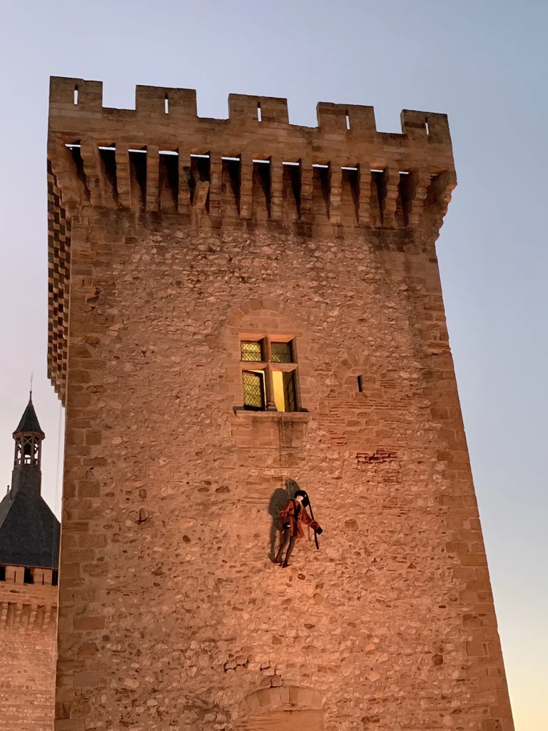 Tower of the Château de Foix with puppet hanging from the window