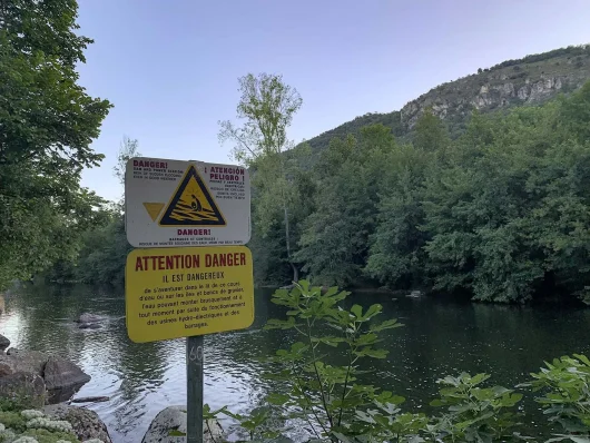 Senyal d'advertència de perill a la vora del riu